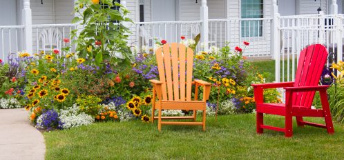 Orange and Red Lawn Chair with Flowers in Background
