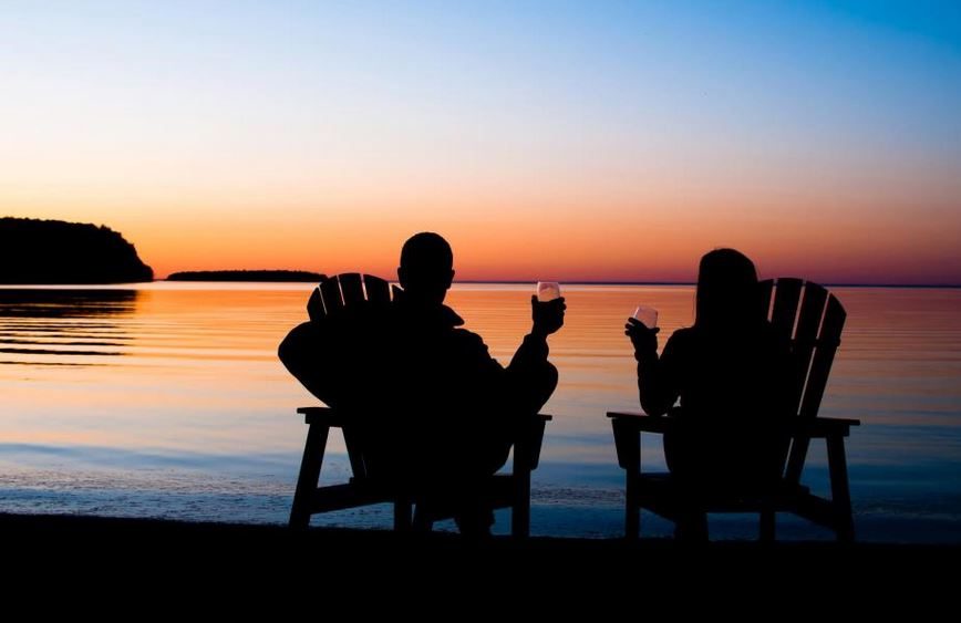 Couple Sitting on Beach with Wine